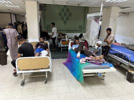 Wounded Palestinians, who were injured in an Israeli strike, lie on beds as Gaza’s overwhelmed Al-Aqsa hospital struggles to treat the wounded, amid the Israel-Hamas conflict, in Deir Al-Balah