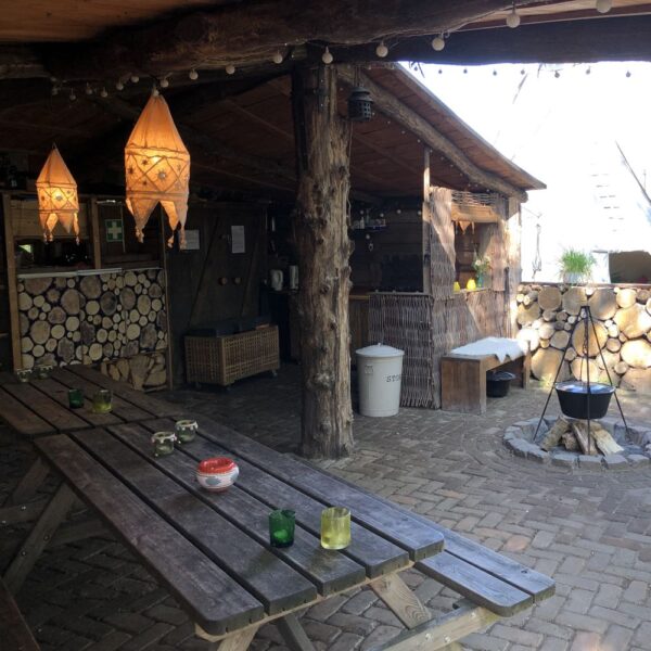 Overdekt terras met picknicktafels en vuurplaats