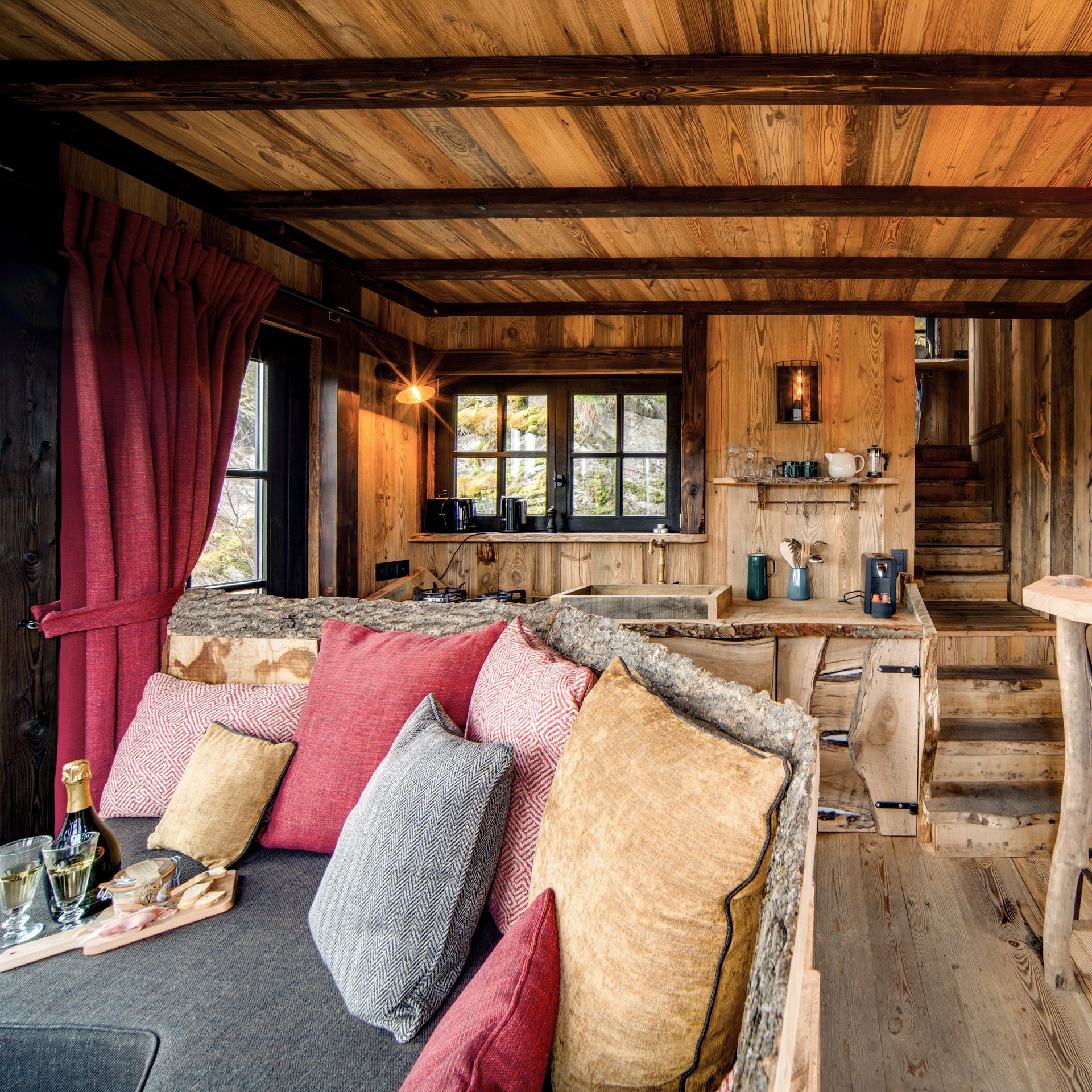 Sfeervolle woonkamer met loungebank en balkenplafond