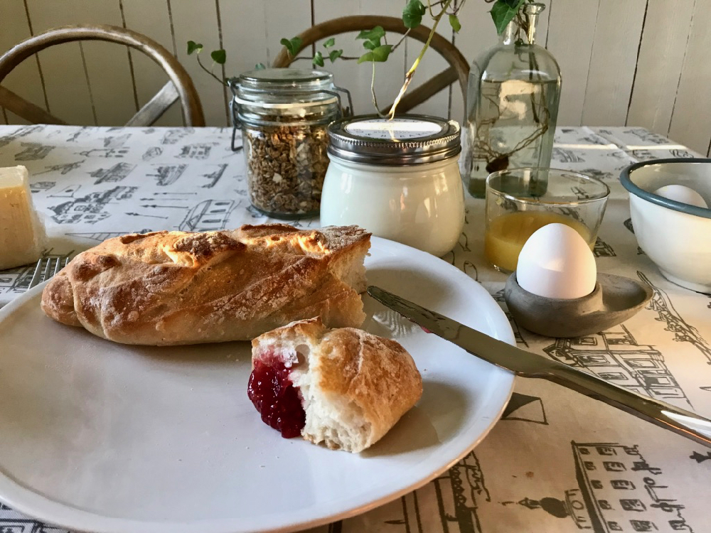 Ontbijt met een eitje, brood met jam en verse melk