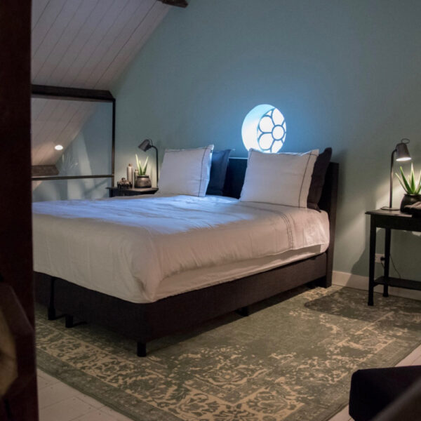 Tweepersoons bed met groot tapijt eronder