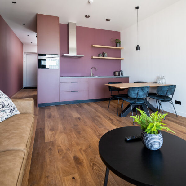 Studio met zithoek, eethoek en roze keuken