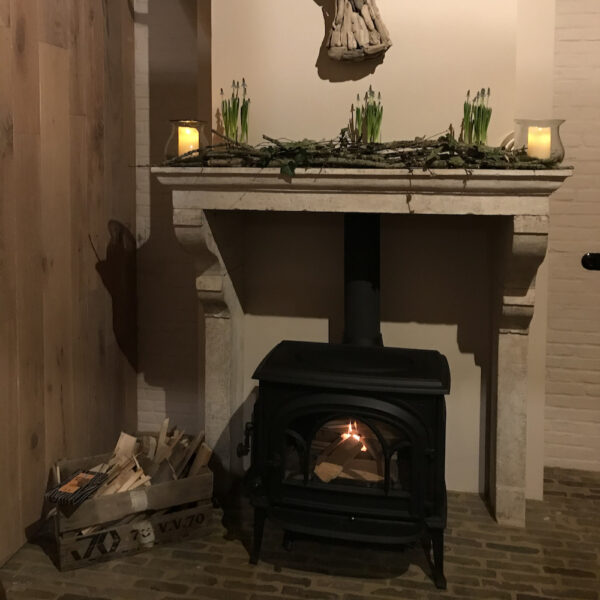 Brandende houtkachel in de hoeve