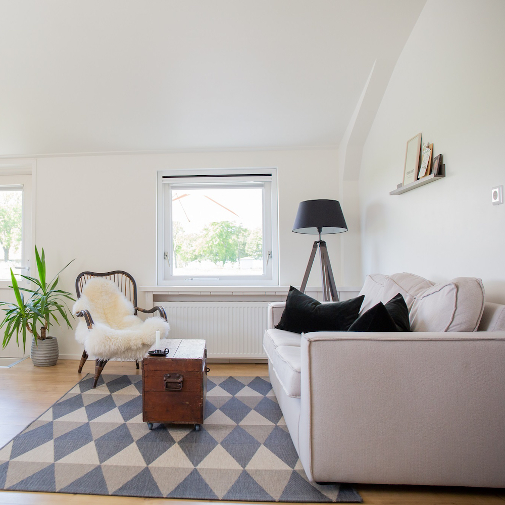 Wohnung 1 Sitzecke Wohnzimmer Korbsessel Schafsfell Sofa Fernseher