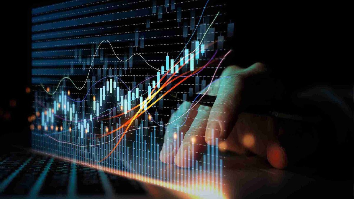 A hand holding a pen directs attention to a holographic representation of a trading chart adorned with diverse lines
