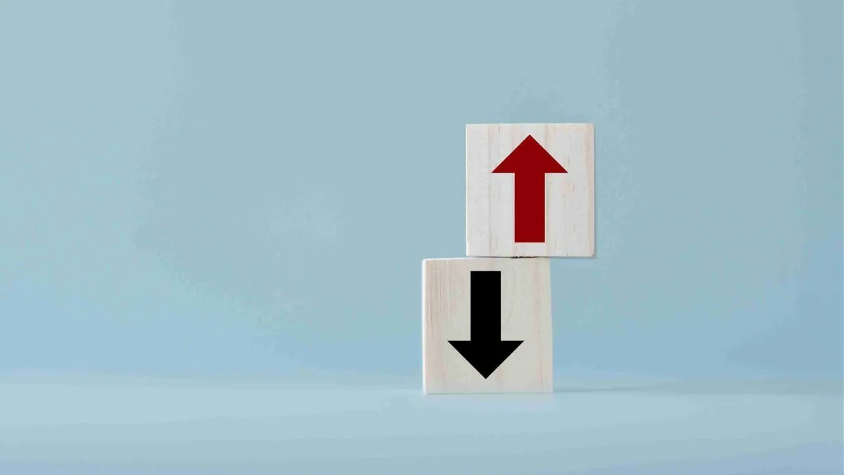 A pair of wooden blocks featuring an encryption of up and down arrows