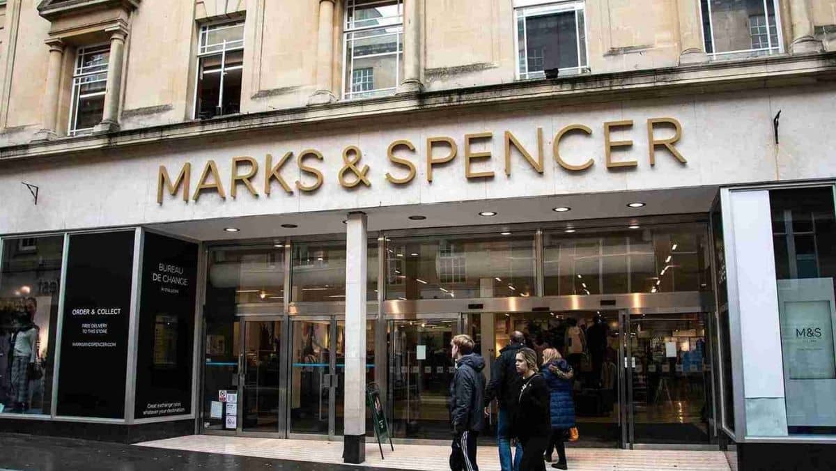 A retail outlet of Marks and Spencer with shoppers passing by