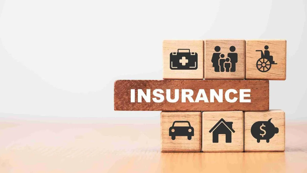 Arrangement of wood blocks, some imprinted with symbols and one with the label INSURANCE