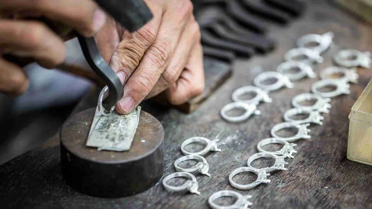 Artisan crafting a silver ring by hand in a jewellery workshop