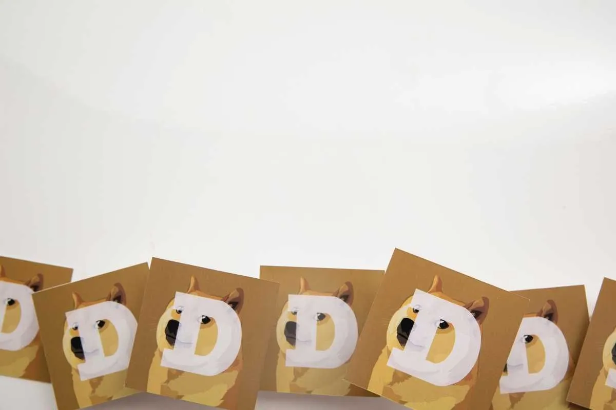 Dog themed paper cutouts forming the word DOGE in a row