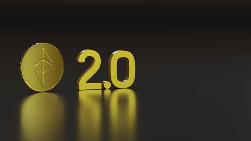 Golden Ethereum coin with  2.0  next to it on a reflective surface