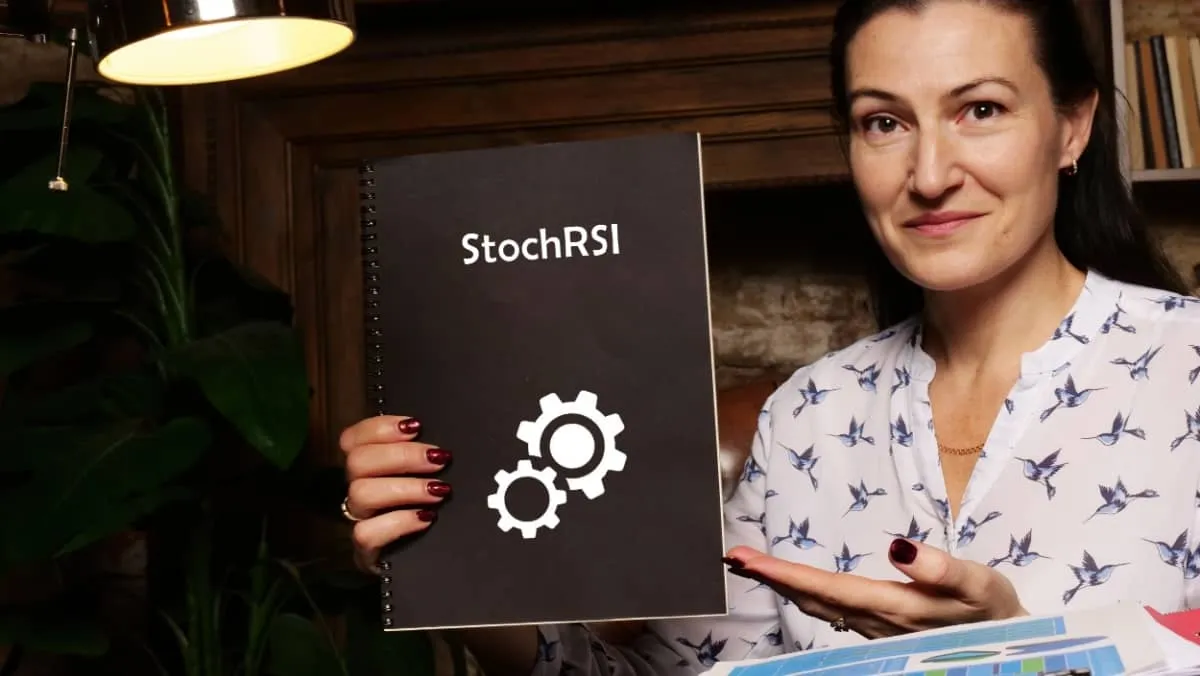 High-resolution business Woman holding black notepad with written text StochRSI Stochastic RSI - closeup shot.