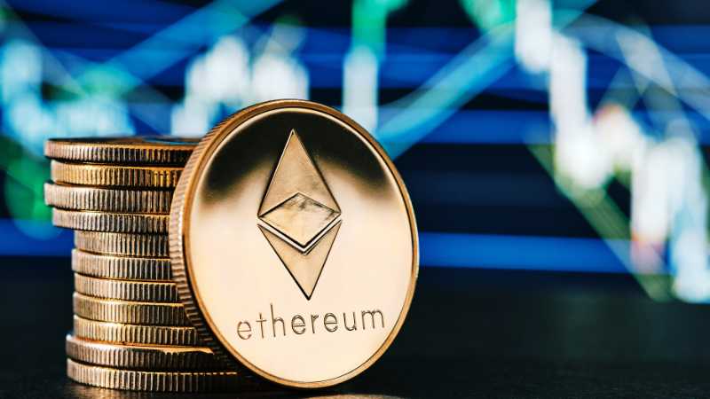 Stack of coins with an Ethereum token in the foreground against a chart background