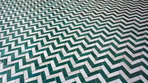 The image shows a geometric patterned floor with a three-dimensional illusion, featuring alternating white and green tiles