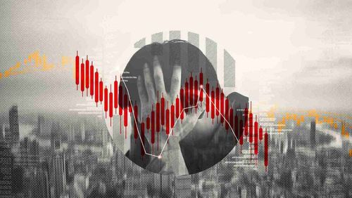 A person holding their head, symbolizing distress, alongside red and orange candlestick patterns