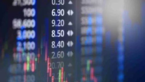 Stock market data on a digital screen and a candlestick patterns