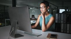 Computer, thinking and night woman reading finance portfolio, stock market database or review ecommerce feedback. Forex investment idea, data analysis or African trader trading NFT, bitcoin or crypto