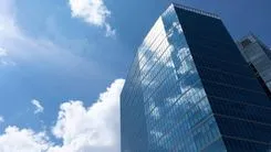 Skyscrapers, High-rise Building From Angle View On Background Of Sky. Cityscape, Tower In Urban Area. Business Development Or Financial Center Concept. Copy Space On Left. Modern Building. Horizontal