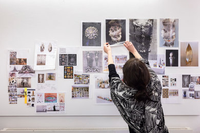 West Dean College Fine Art student putting up work on the wall