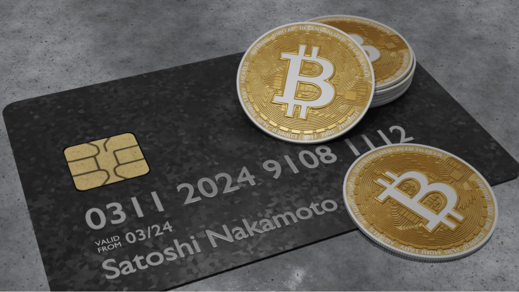 A 3D illustration of a credit card with the name Satoshi Nakamoto on it and some Bitcoins, represented in physical gold coin form, on top of the card and surface below.