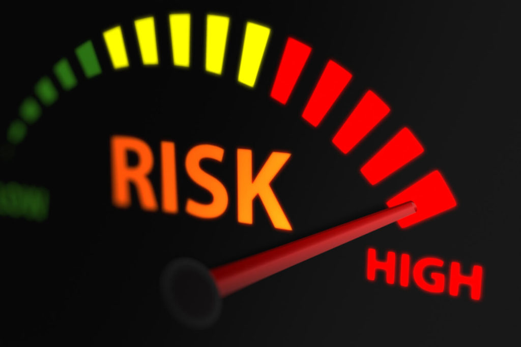A vector graphic of a risk meter which goes from low to high risk. A risk button pointing upwards towards middle risk in the centre of the meter.