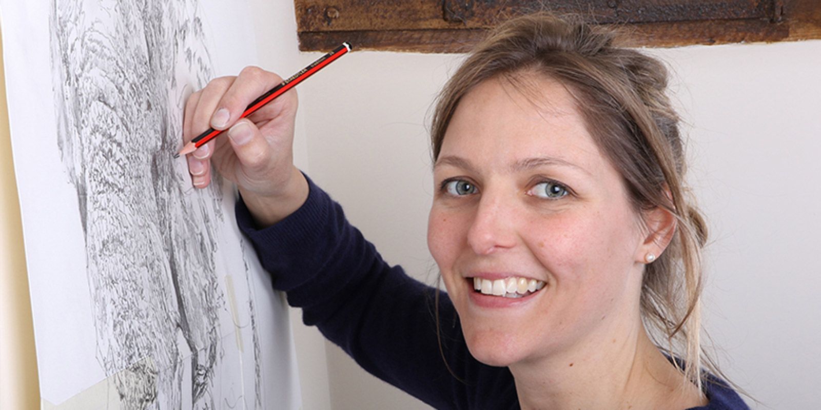 Zaza Shelley drawing in the studio, smiling